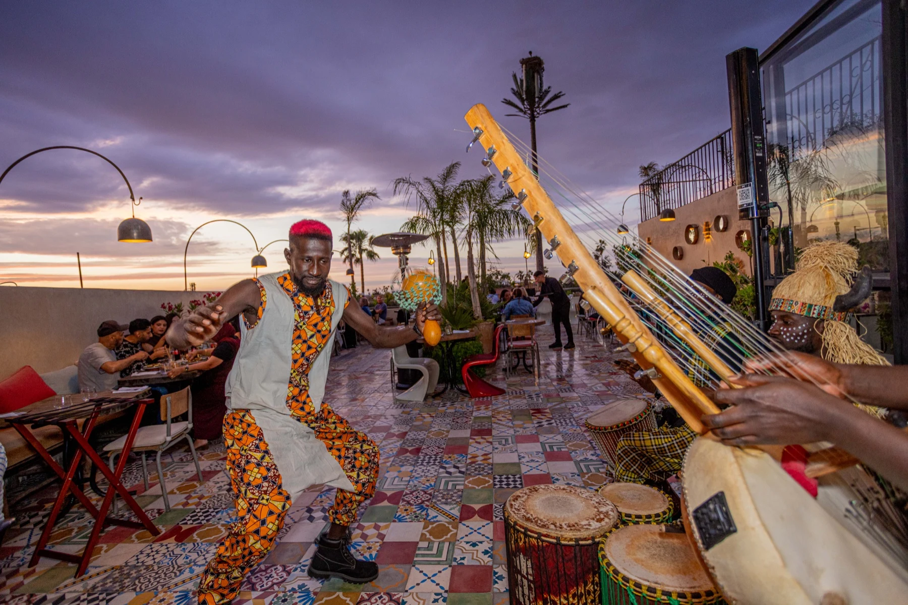African dancers and musicians performing at sunset on Coco Rooftop